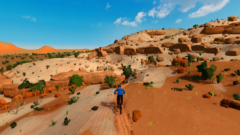 Rider on a sandy trail below sandstone ledges and fins at Navajo Rocks